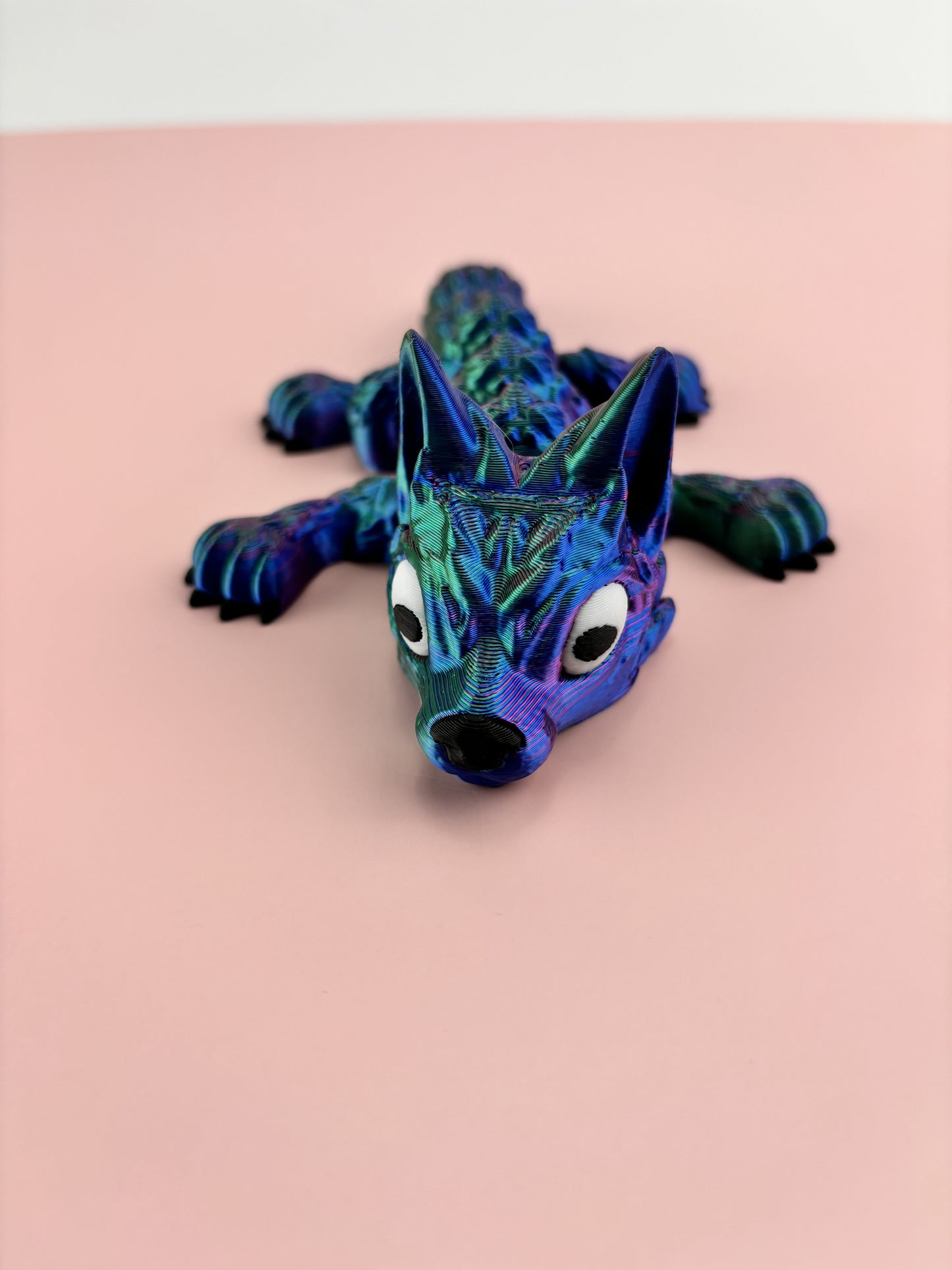 Tiny Wolf Pup 3D Printed in Vibrant Blues, Purples, and Greens.