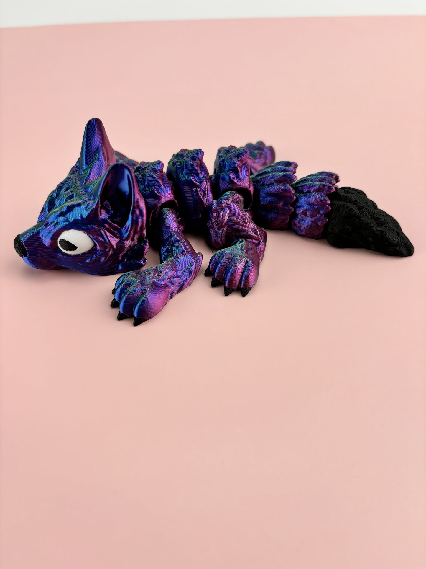Tiny Wolf Pup 3D Printed in Vibrant Blues, Purples, and Greens.